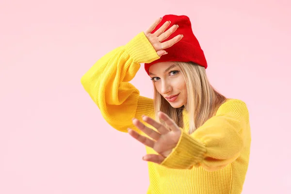 Junge Frau im warmen Pullover auf farbigem Hintergrund — Stockfoto