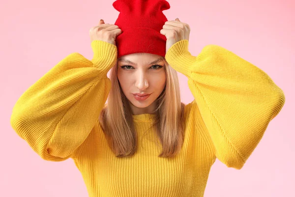 Young woman in warm sweater on color background — Stock Photo, Image