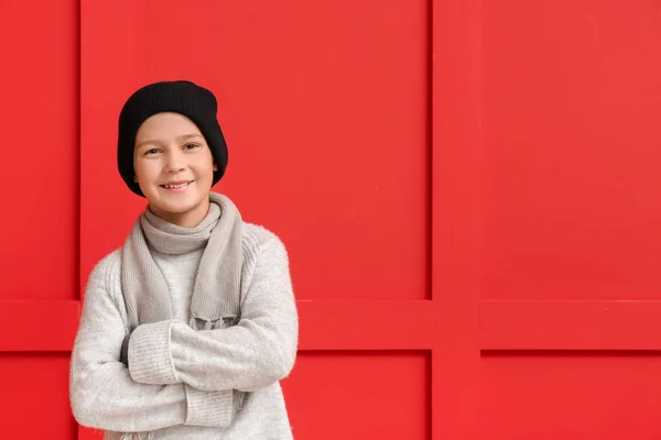 Cute little boy in winter clothes on color background — Stock Photo, Image