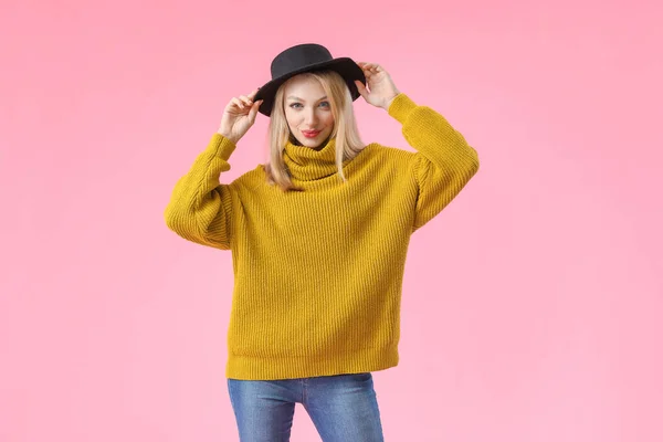 Mujer joven en suéter cálido sobre fondo de color — Foto de Stock