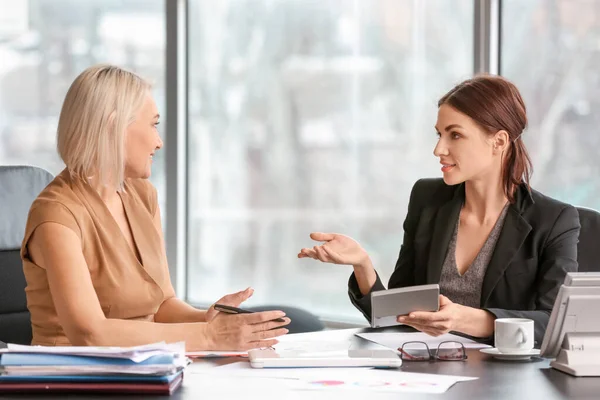 Female accountant and her colleague working in office — Stock Photo, Image