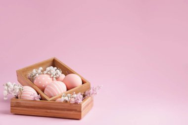 Renkli arka planda güzel Paskalya yumurtaları ve çiçekli kutular