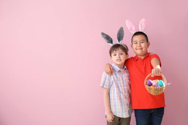 Paskalya yumurtaları ve renkli kulakları olan küçük çocuklar.