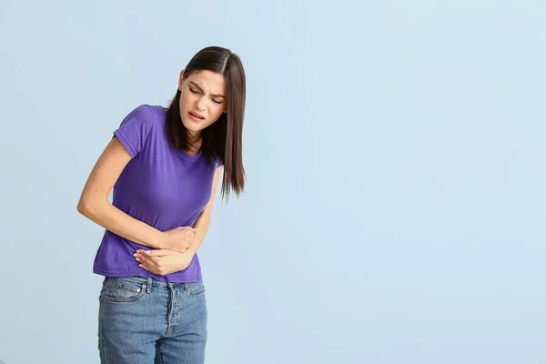 Young Woman Suffering Menstrual Cramps Light Background — Stock Photo, Image
