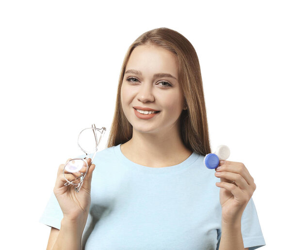 Young woman with contact lens case and eyeglasses on white background