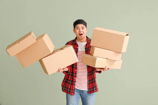 Asian Man Dropping Moving Boxes Color Background — Stock Photo, Image