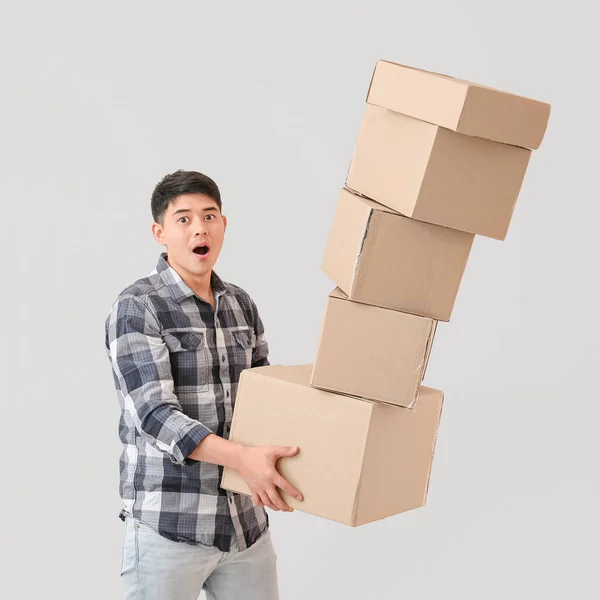 Asian Man Dropping Moving Boxes Light Background — Stock Photo, Image