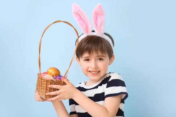 Kleiner Junge Mit Ostereiern Und Hasenohren Auf Farbigem Hintergrund — Stockfoto