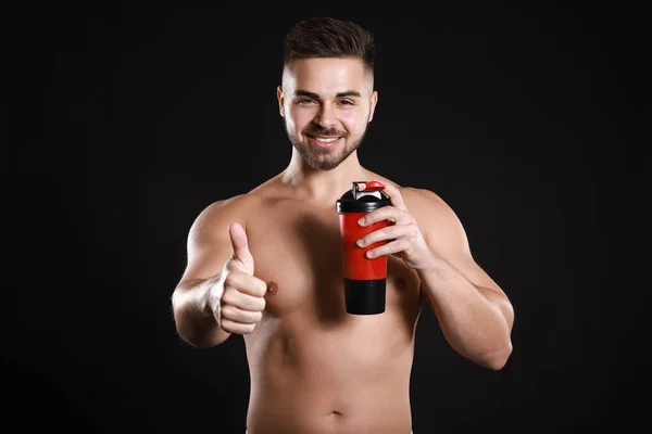 Sporty Man Protein Shake Showing Thumb Dark Background — Stock Photo, Image