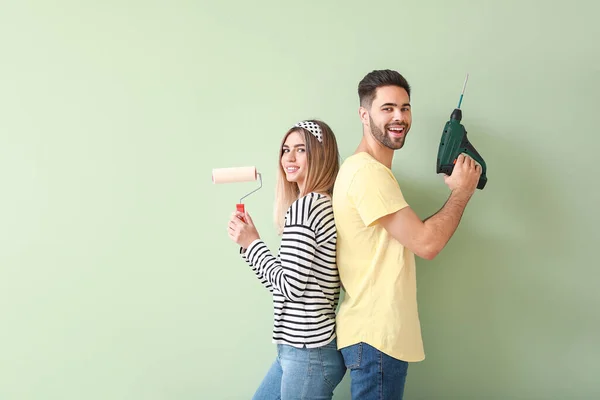 Young Couple Paint Roller Drill Color Wall New Apartment — Stock Photo, Image
