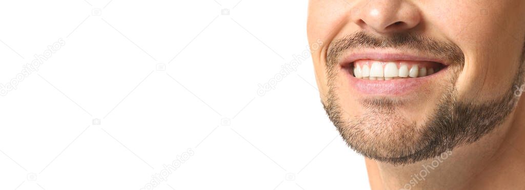 Handsome man with healthy teeth on white background with space for text