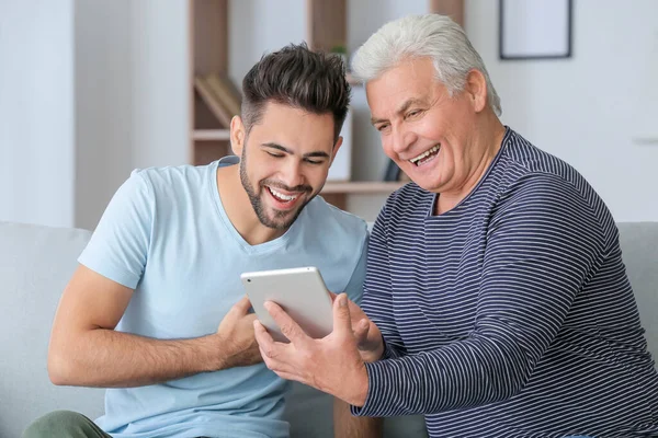 Young Man His Father Tablet Computer Home — Stockfoto