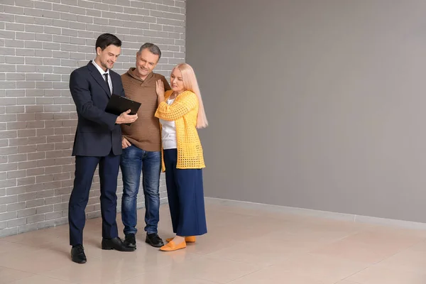 Male Real Estate Agent Working Mature Couple Indoors — Stock Photo, Image