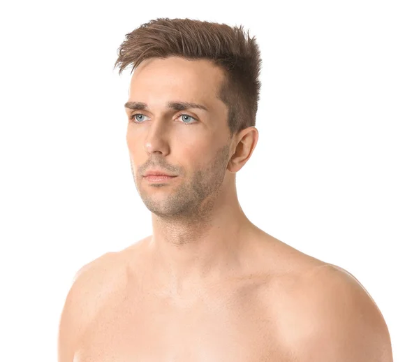 Handsome young man with shaved part of his face on white background Stock Photo by ©serezniy