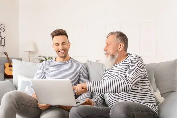 Senior Man Zijn Volwassen Zoon Met Behulp Van Laptop Thuis — Stockfoto