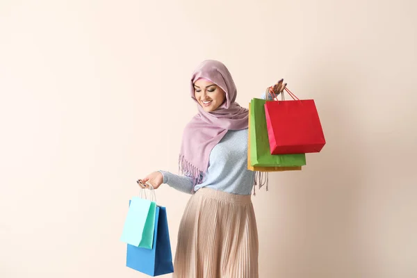 Junge Araberin Mit Einkaufstaschen Auf Farbigem Hintergrund — Stockfoto