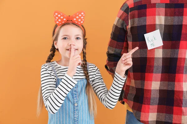 Little Girl Playing Prank Her Father Color Background April Fools — Stock Photo, Image