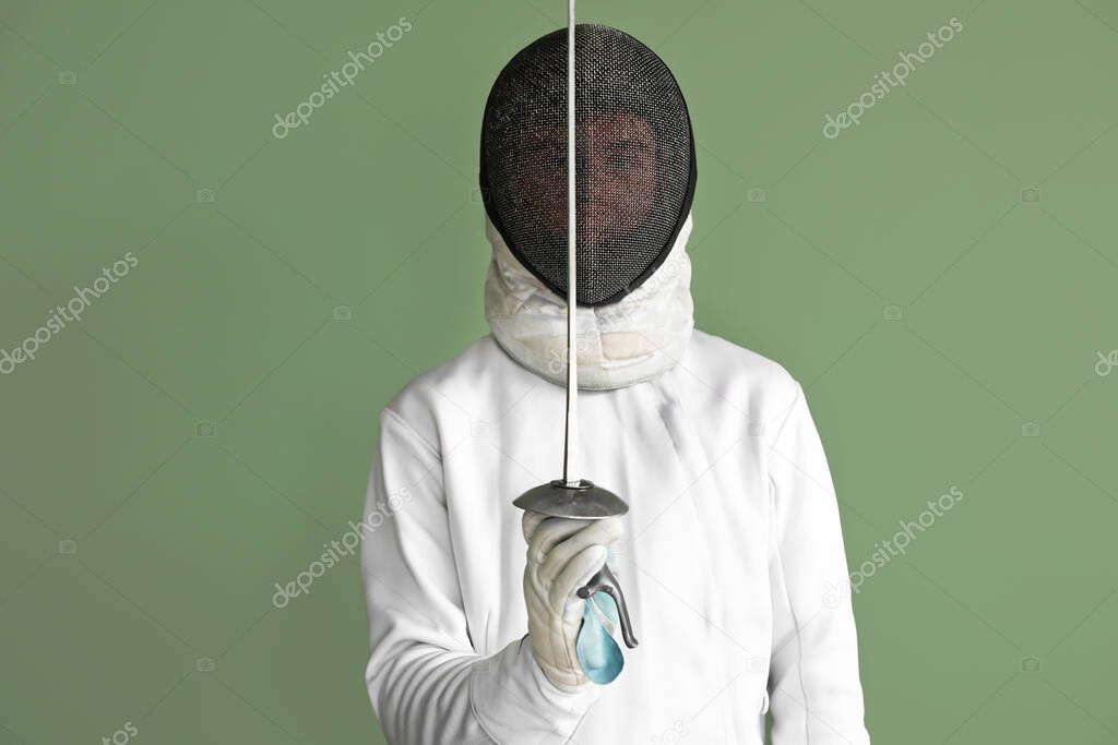 Young male fencer on color background