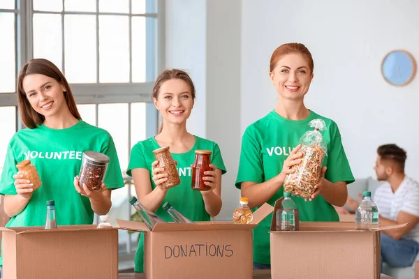 Team of volunteers with products indoors