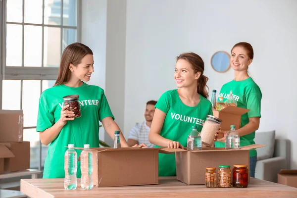 Team Volunteers Products Indoors — Stock Photo, Image