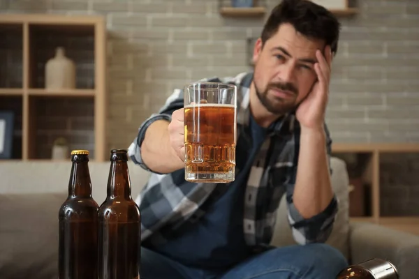 Man drinking beer at home. Concept of alcoholism