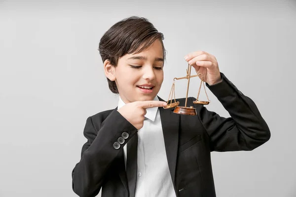 灰色の背景に正義のスケールを持つ小さな弁護士 — ストック写真
