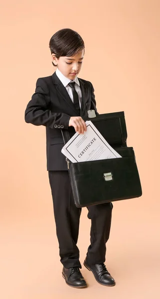 Little Lawyer Putting Document Briefcase Color Background — Stock Photo, Image