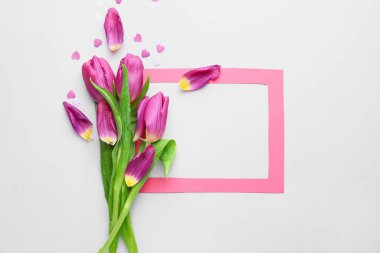 Bir buket güzel çiçek ve beyaz arkaplanda boş çerçeve.