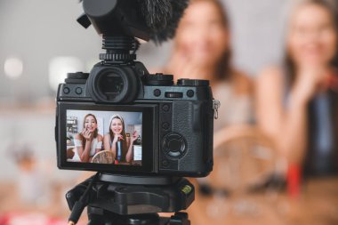 Young beauty bloggers recording video at home clipart