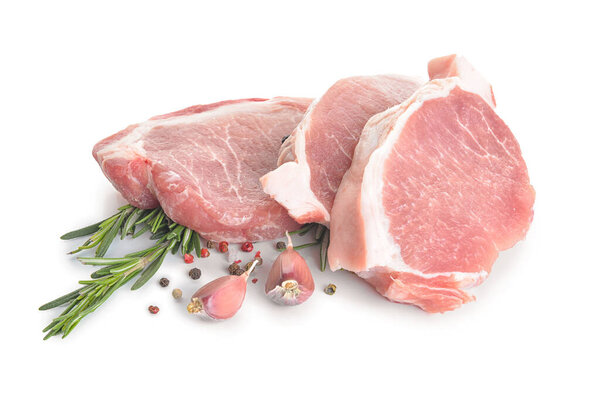 Raw pork meat with spices and herbs on white background