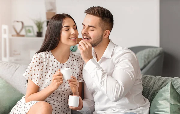 Beautiful Young Couple Eating Chocolate Home — Stock Photo, Image