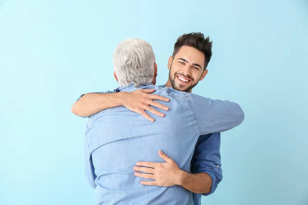 Young Man His Father Hugging Color Background — Stock Photo, Image