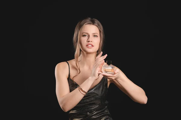Güzel Genç Kadın Koyu Arka Plan Üzerinde Parfüm Şişe — Stok fotoğraf