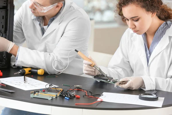 stock image Electronic technicians working in service center