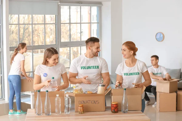 Team of volunteers with products indoors