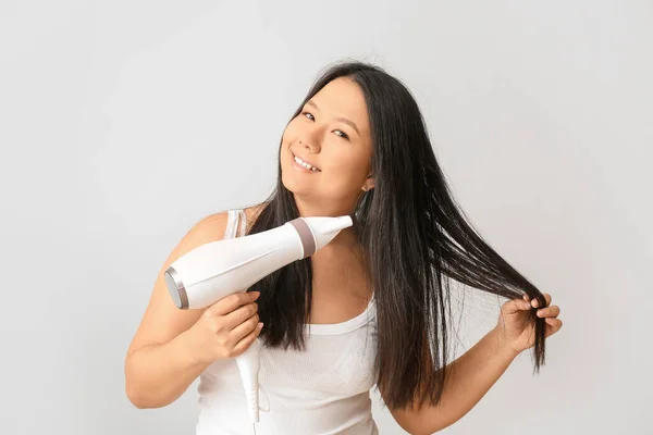 Beautiful Asian Woman Hair Dryer Light Background — Stock Photo, Image