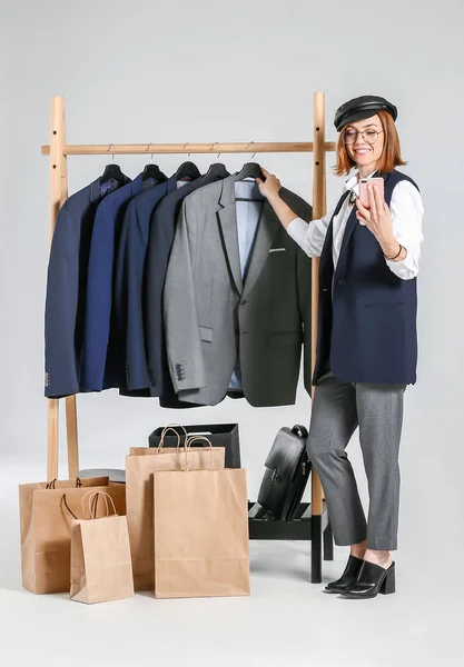 Female Stylist Rack Male Clothes Recording Video White Background — Stock Photo, Image