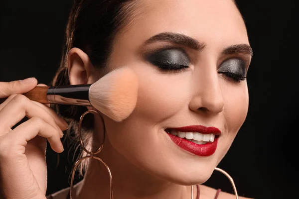 Beautiful Young Woman Applying Makeup Dark Background — Stok fotoğraf