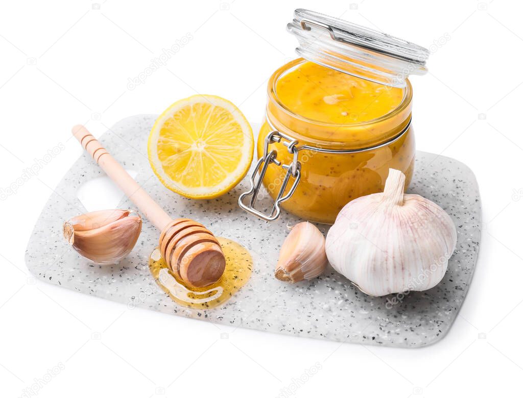 Jar of tasty honey mustard sauce on white background