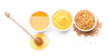 Bowls of honey, mustard and sauce on white background