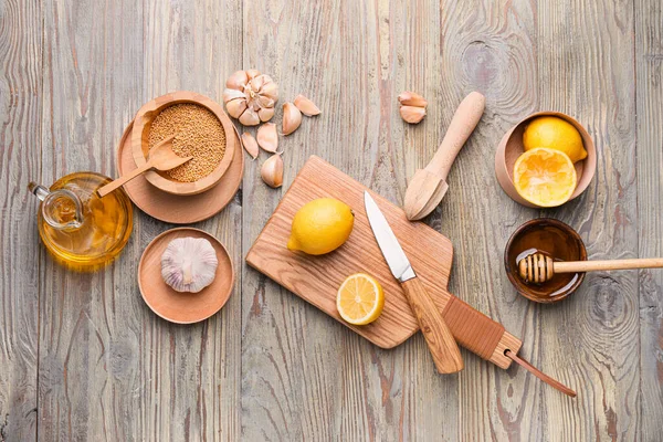 Ingredients for honey mustard sauce on wooden background