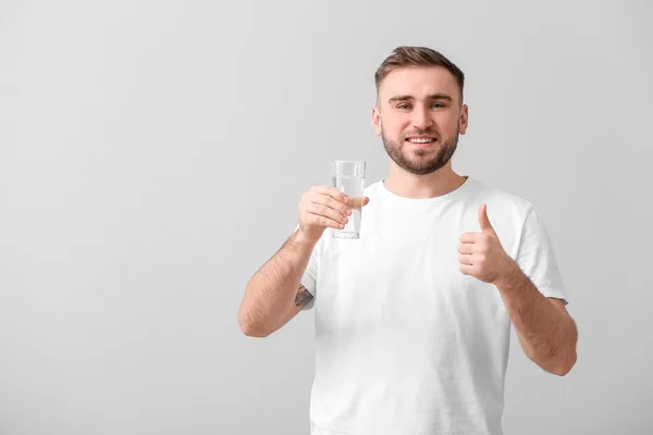 Young Man Glass Water Showing Thumb Light Background — Stock Photo, Image