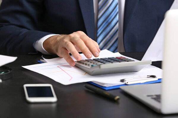 Male accountant working in office, closeup
