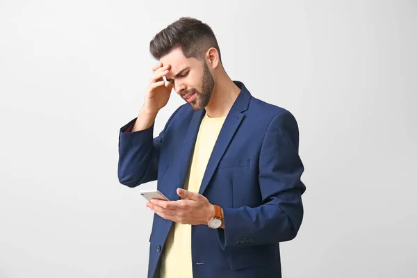 Worried Young Man Mobile Phone Light Background — Stock Photo, Image