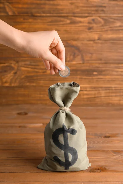 Female Hand Putting Coin Bag Money Wooden Background — Stock Photo, Image