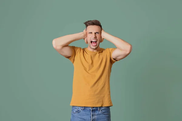 Verontwaardigde Man Het Bedekken Van Oren Kleur Achtergrond — Stockfoto