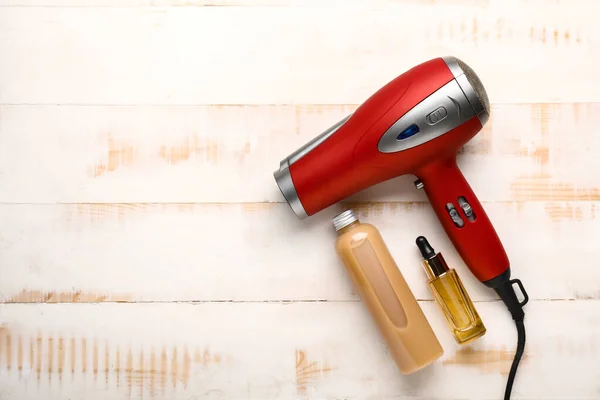 Modern Hair Dryer Cosmetics Light Wooden Background — Stock Photo, Image