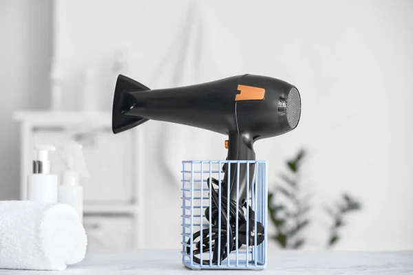 Modern hair dryer on table