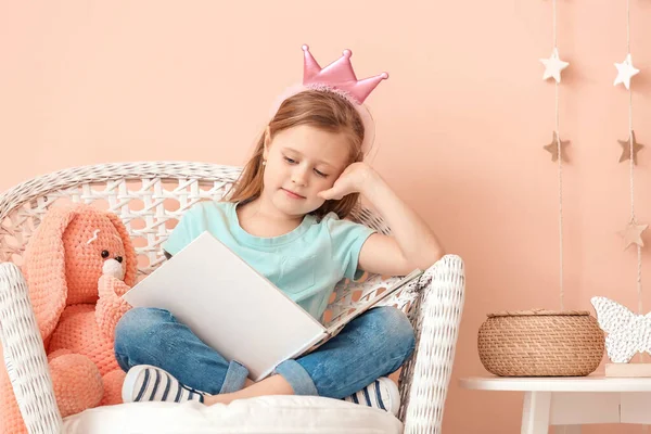 Cute Little Girl Reading Book While Sitting Armchair Color Wall — Stock Photo, Image