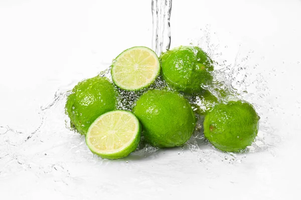 Water Pouring Fresh Limes White Background — Stock Photo, Image